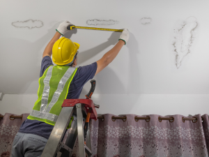 inspecting a leaking roof - Milford Roofing Contractor