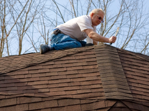 Greenwich roofing contractors inspecting a roof for leaks.