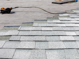 Expert Darien roofing services team installing a composition roof.