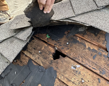 Roofing contractor repairing a leaky roof in Darien.