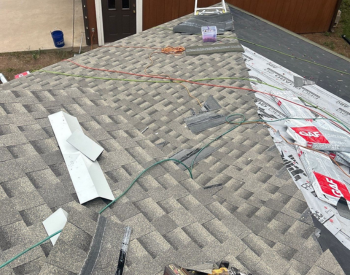 L.A. Barnaby & Sons team conducting roof repairs in Darien.