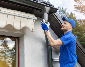 L.A. Barnaby & Sons team performing gutter maintenance in Trumbull